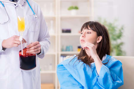 Doctor discussing blood transfusion with patientの写真素材