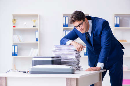 Businessman making copies in copying machine