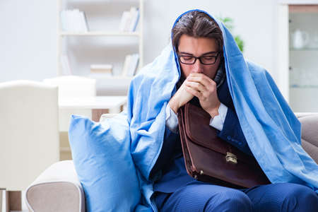 Sick employee staying at home suffering from flueの写真素材