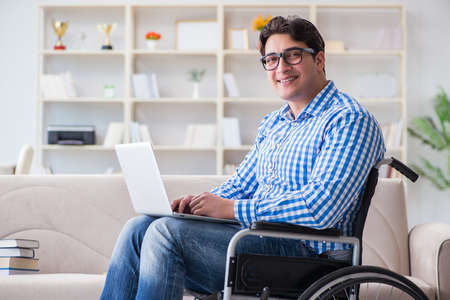 Young student on wheelchair in disability conceptの写真素材