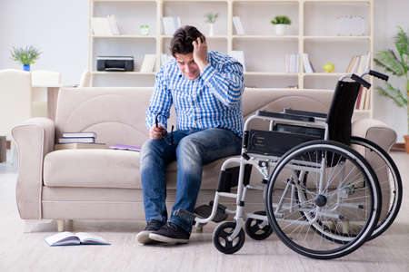 Young student on wheelchair in disability conceptの写真素材