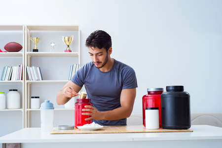 Athlete tasting new protein supplements for better musclesの写真素材