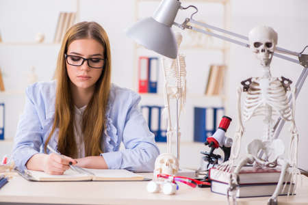 Student sitting in classroom and studying skeleton