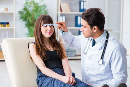 Ophthalmologist is checking up patient in eye doctor hospitalの写真素材