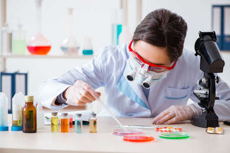 Lab assistant in drug synthesis conceptの写真素材
