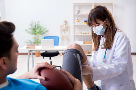 American football player with injury visiting doctor