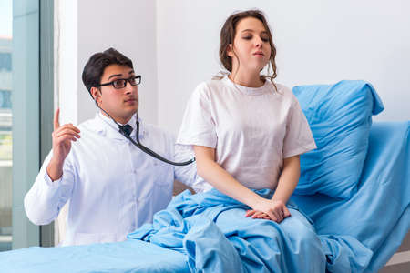 Doctor visiting patient in hospital room