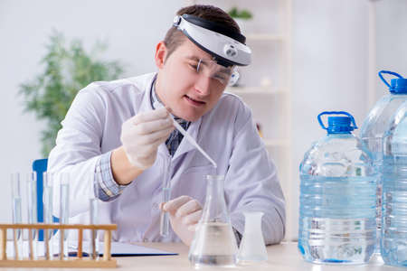 Young chemist student experimenting in lab