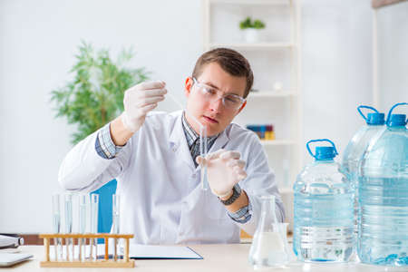 Young chemist student experimenting in labの写真素材