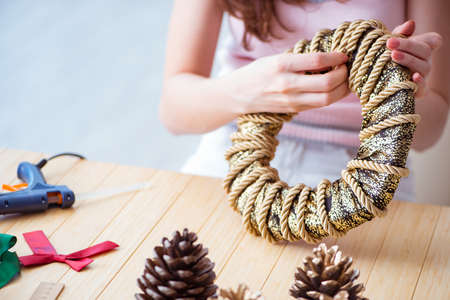 Woman doiing DIY festive decorations at home