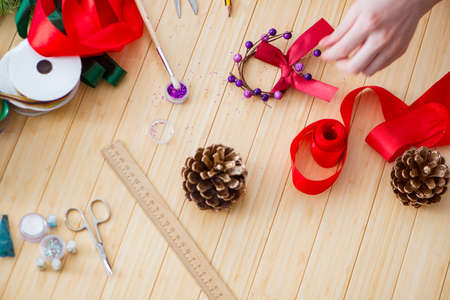 Woman doiing DIY festive decorations at homeの写真素材