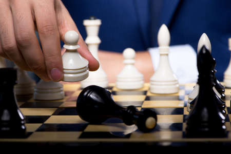 Businessman playing chess in strategy concept