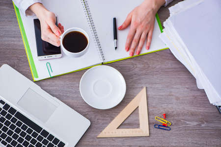 Top view of working desk with handsの写真素材