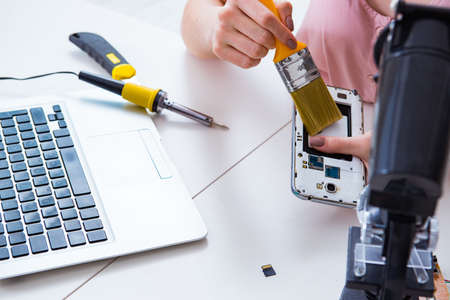 Mobile phone repair in workshopの写真素材