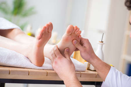 Foot massage in medical spaの写真素材