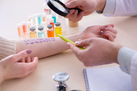 Doctor testing allergy reaction of patient in hospitalの写真素材