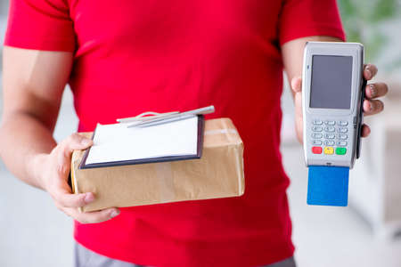 Parcel delivery being paid with pos and credit cardの写真素材