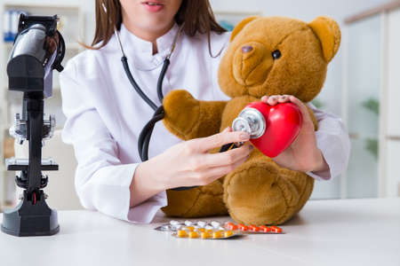 Child checking soft toy healthの写真素材