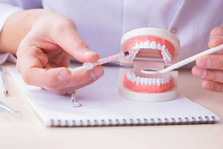 Dentist working teeth implant in medical lab