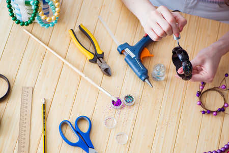 Woman making jewelry at home