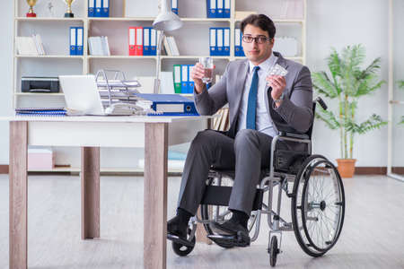 Disabled businessman working in the officeの写真素材