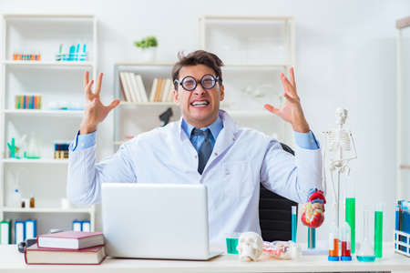 Funny doctor having fun in hospital labの写真素材