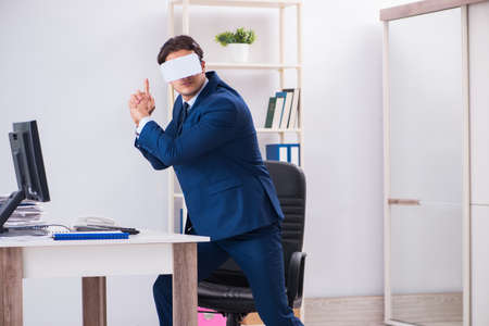 Employee using virtual reality glasses in officeの写真素材