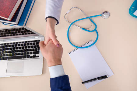 Man signing medical insurance contractの写真素材