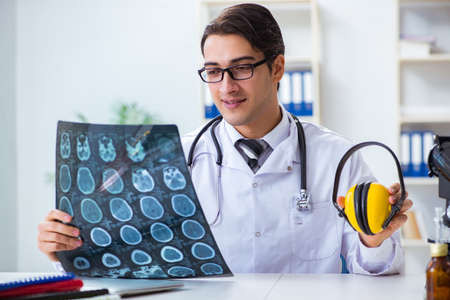 Safety doctor advising about noise cancelling headphonesの写真素材