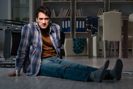 Man fell off wheelchair sitting on the floorの写真素材