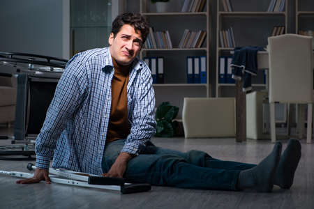 Man fell off wheelchair sitting on the floorの写真素材