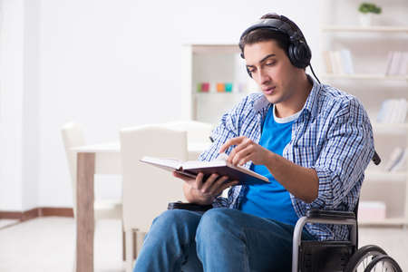 Disabled man listening to music in wheelchairの写真素材