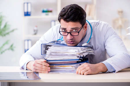 Busy doctor with too much work in hospitalの写真素材