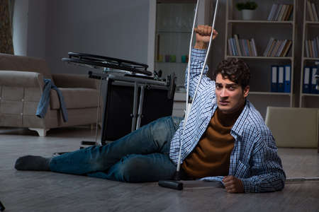 Man fell off wheelchair sitting on the floorの写真素材