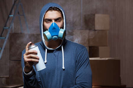 Graffiti painter in dark smokey roomの写真素材