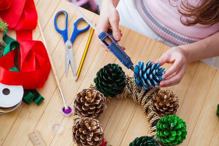 Woman doiing DIY festive decorations at home