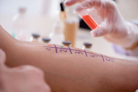 Doctor testing allergy reaction of patient in hospitalの写真素材