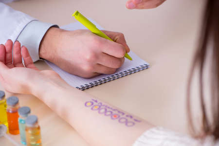 Doctor testing allergy reaction of patient in hospitalの写真素材