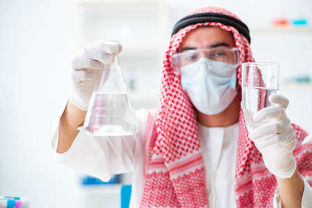 Arab chemist checking the quality of drinking waterの写真素材