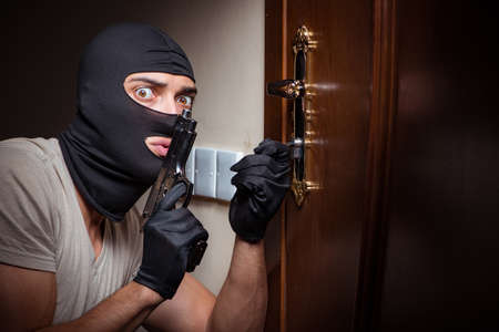 Burglar wearing balaclava mask at crime sceneの写真素材