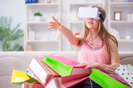 Young woman doing shopping with virtual reality glasses