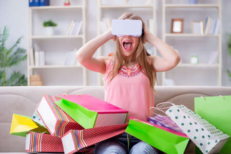 Young woman doing shopping with virtual reality glasses