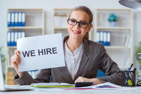 Businesswoman sitting in office with messageの写真素材