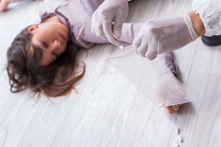 Forensic investigator at the crime scene investigating woman mur