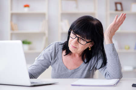 Senior woman struggling at computer