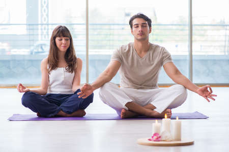 Personal coach helping during yoga sessionの写真素材