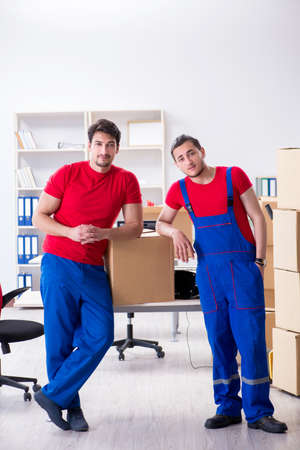 Two contractor employees moving personal belongingsの写真素材