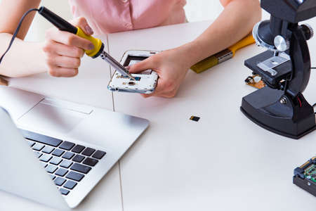 Mobile phone repair in workshopの写真素材