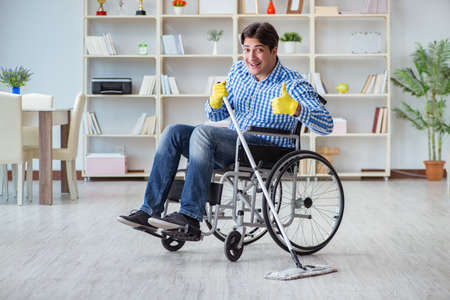 Disabled man on wheelchair cleaning home