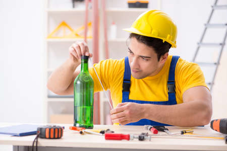 Drunk engineer working in the workshopの写真素材